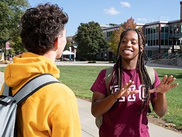 Students in RIC gear talking on campus