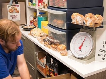 Someone stocking Learning for Life food pantry