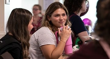Student drinking from refillable water bottle
