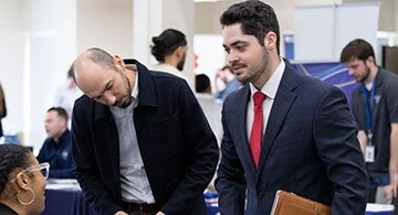 Students and alumns meeting employers at job fair
