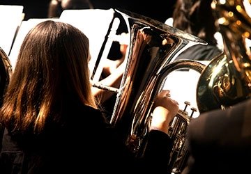 Tuba and low brass players in orchestra