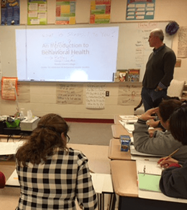 Professor instructing a class using a powerpoint presentation 