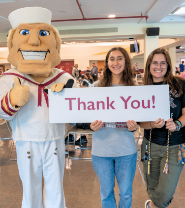 Students with Anchorman mascott holding thank you sign