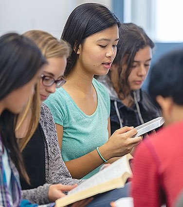 High schoolers reading in class