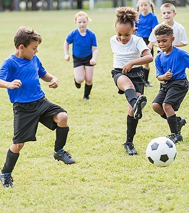 Young kids playing soccer