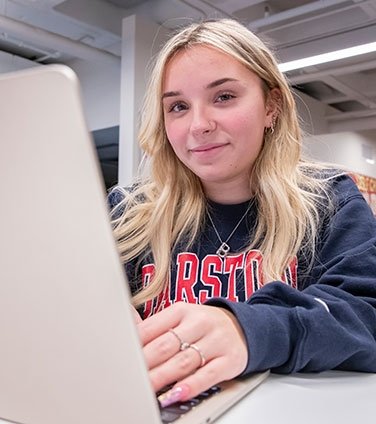 Smiling student at laptop