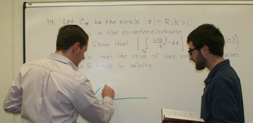 RIC Math students in class in front of whiteboard