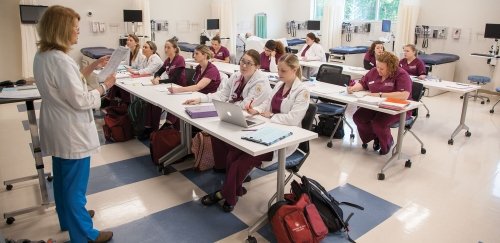 A classroom of nursing students listening to their professor