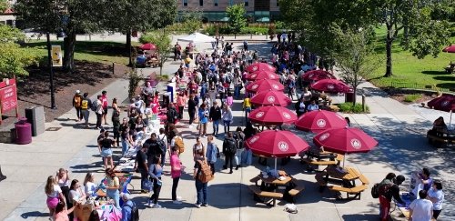 Drone overhead shot of crowded quad during student activities fair
