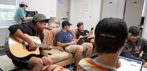 Freshmen hanging out in residence hall common room