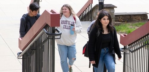 Students walking up exterior library steps