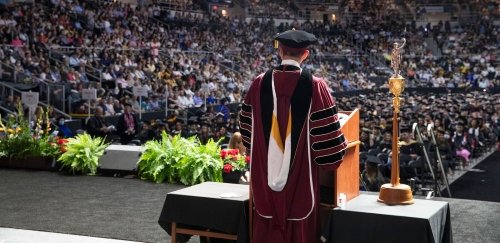 Commencement ceremony, speaker at podium, looking out at crowd