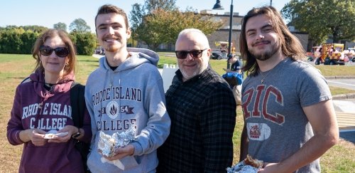 A family together wearing RIC gear at homecoming