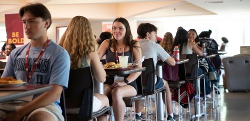 Students eating at high top tables in Donovan