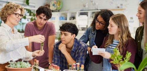 High School science teacher showing students specimens