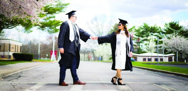 RIC Class of 2021 graduates Ananya Jantawan and Jeffery Kinnie pose for a graduation photo