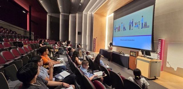 Joise Carzon and Estrellita Moronta, social work professors, speaking in auditorium to highschoolers