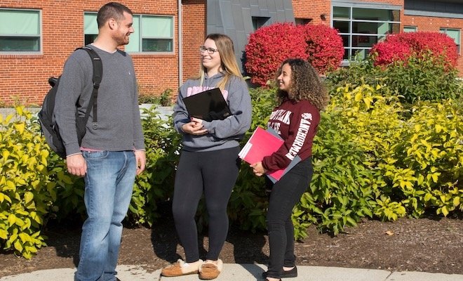 Three students having a conversation outside