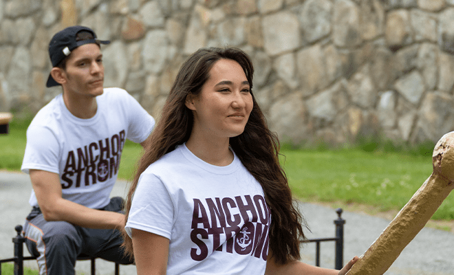 Two students out on the quad smiling wearing "anchor strong" tee shirts