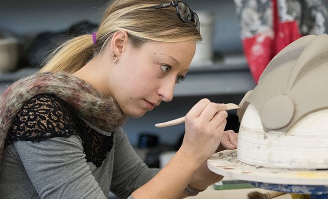 Sculpture student works on project