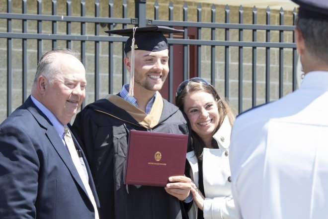 Male student with family at commencement