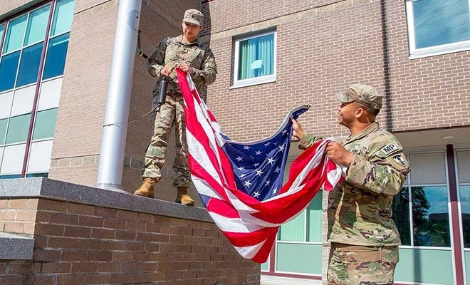 Military students raising a flag