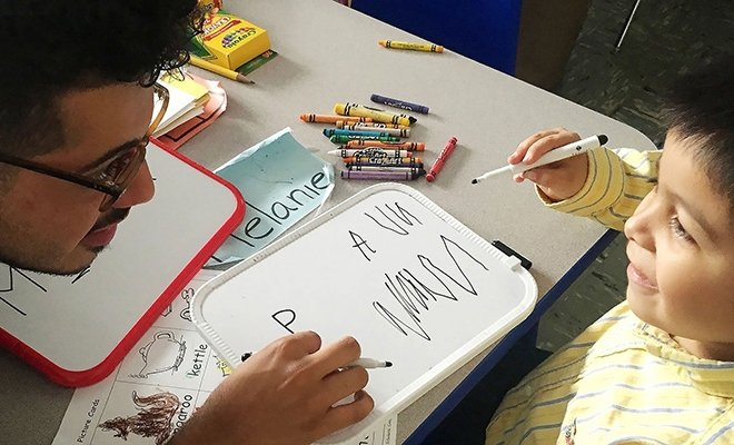 Teacher helping young student