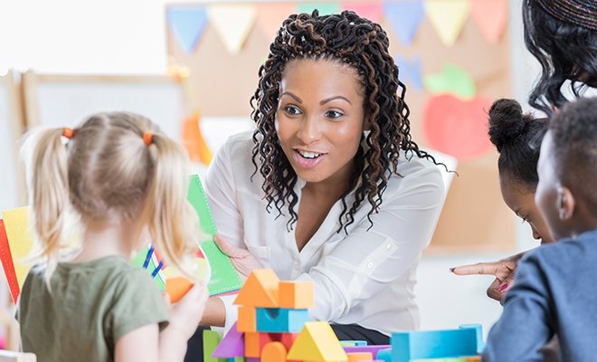 Adult enthusiastically working with preschoolers