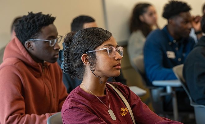 Diverse student group sitting at desks during Center for Scholar Development celebration