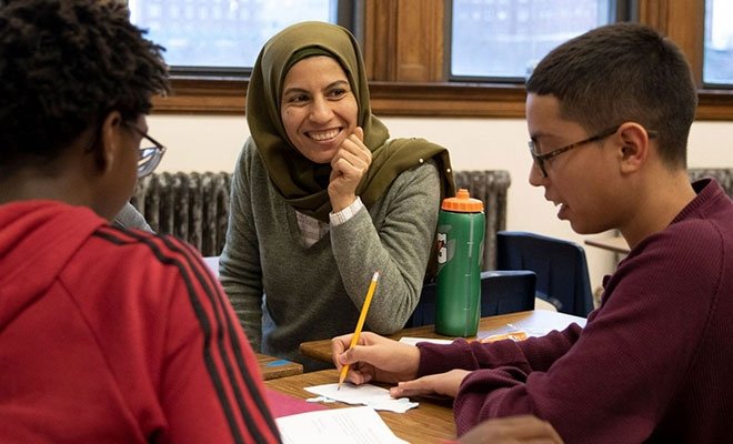 Instructor working at desks with students