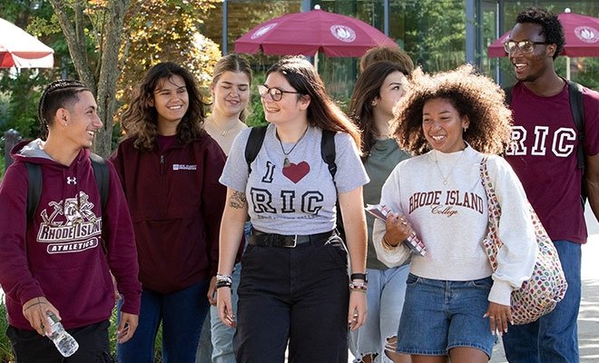 Students in RIC gear walking in sunshine on campus