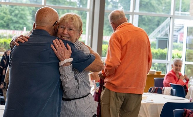 People hugging at a reunion