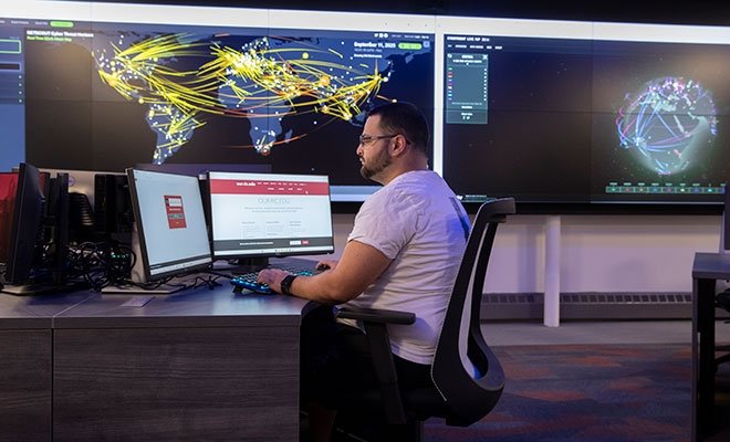 Person working at two monitors in the cyber range