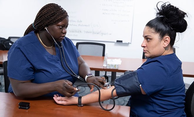 Students practicing taking blood pressure