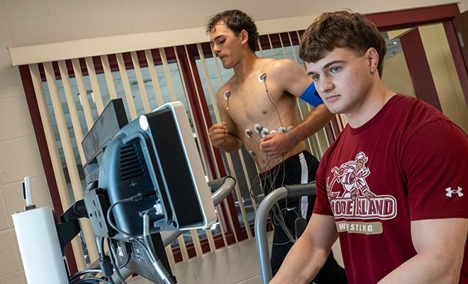 Student working with subject running on a tread mill, usng metabolic cart