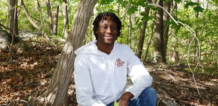 Kwesi Amoa sitting in the woods