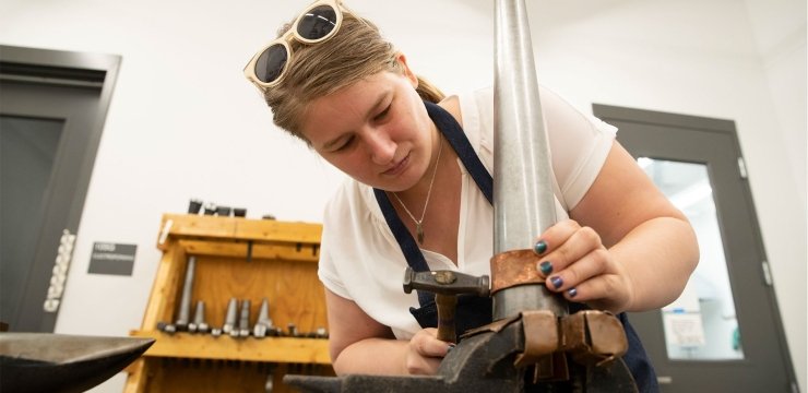 Greer Howard working on making jewelry in a RIC studio