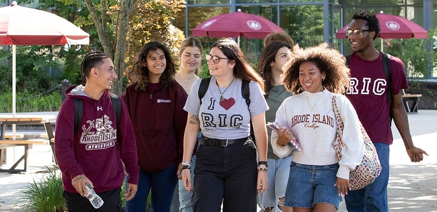 Students in RIC gear walking in sunshine on campus